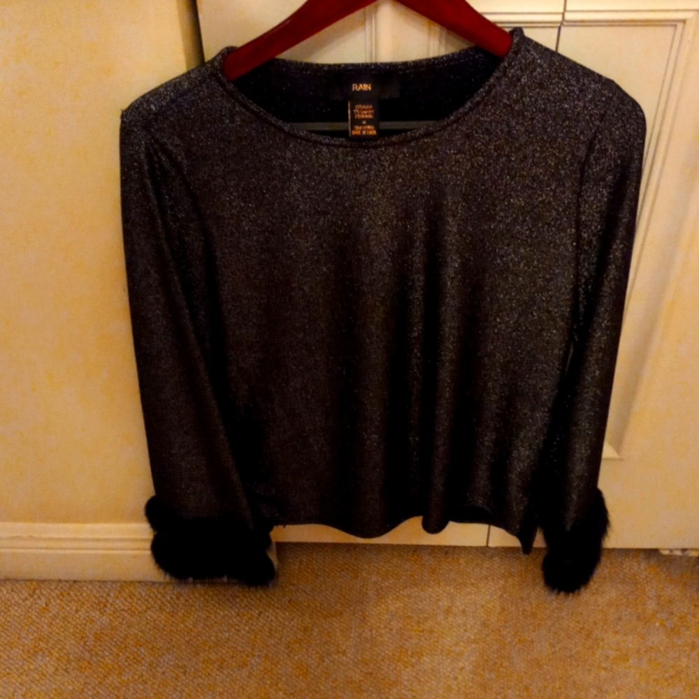 Nice evening wear black blouse with fur on the sleeve the name is rain